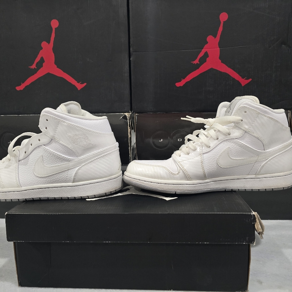 This is a Nike Air Jordan 1 Mid in the all-white colorway, possibly featuring a